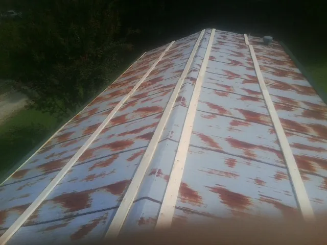 Rusted metal roof panels with new wood purlins before replacement — Storm Damage Roof Repair in Ventnor City by Roofing Brothers