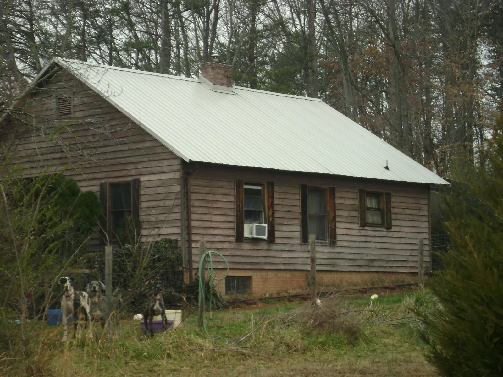 White metal roof on an old wood sided farmhouse, from a Metal Roof Installation job in Ventnor City